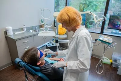 patient getting his dental bridge checked on at Brilliant Smiles in Austin, TX