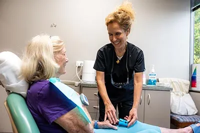 Dr. Rocio Muñoz-Roquero speaking to patient about a dental procedure