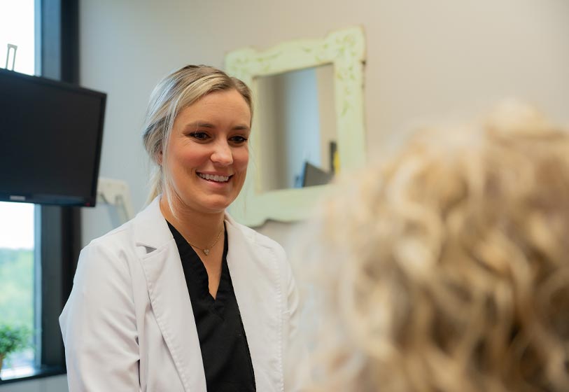 Dr. Tianne Voorhees speaking to a patient during a dental consult